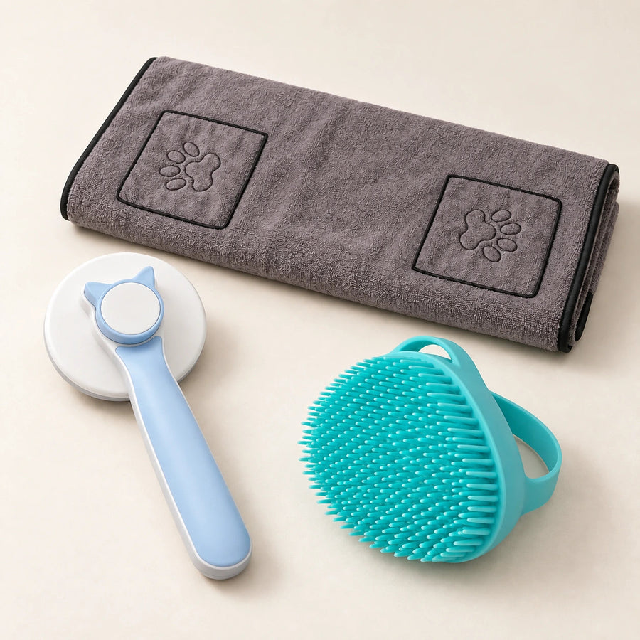 Blue grooming brush and turquoise bath brush beside a gray towel with two paw-detail hand pockets.