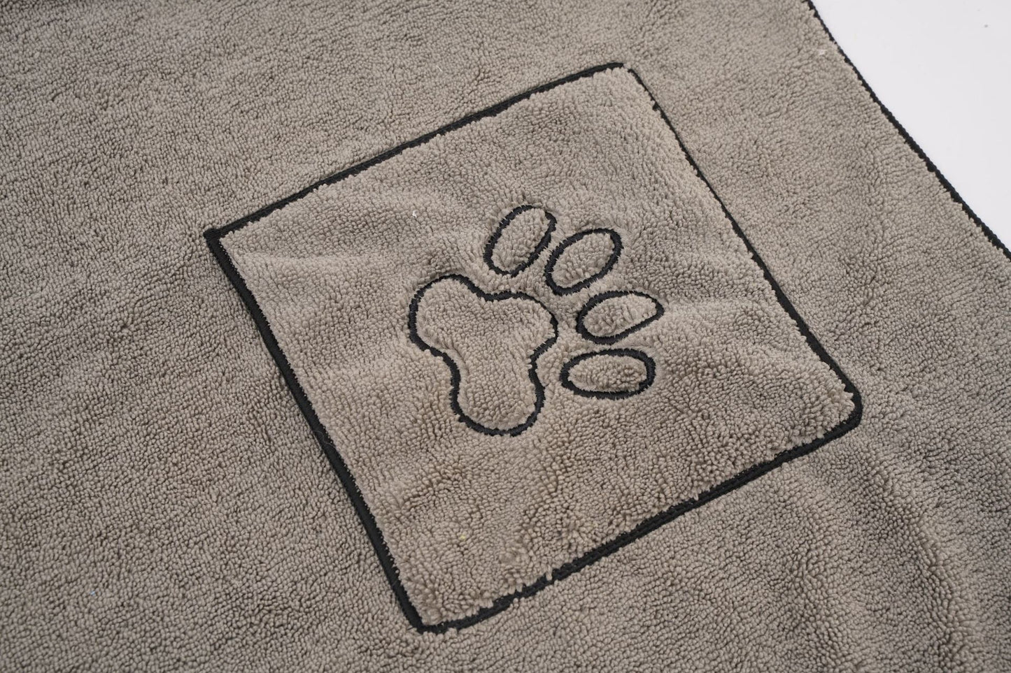 Close-up of paw-detail hand pocket on gray pet towel