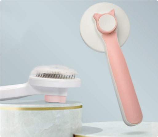 Pink self-cleaning pet grooming brush with push-button hair release