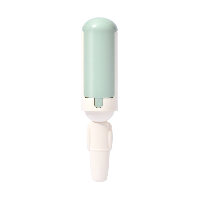 White and green reusable pet hair roller on a white background