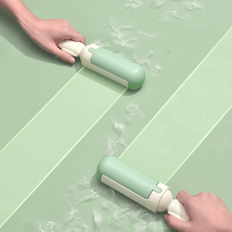 White and green roller gathering loose pet hair from fabric