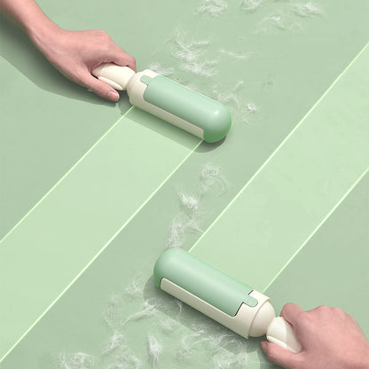 White and green roller gathering loose pet hair from fabric