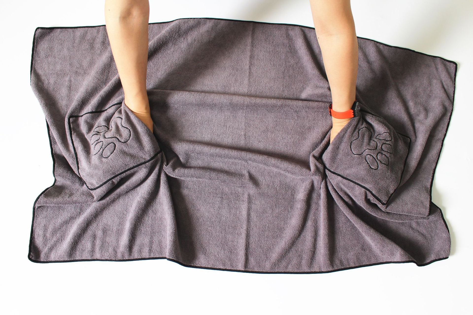 Gray pet drying towel held by its two hand pockets