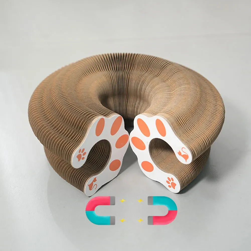 Accordion cat scratcher folded into a circular form, with paw-print end panels and magnetic closures shown.