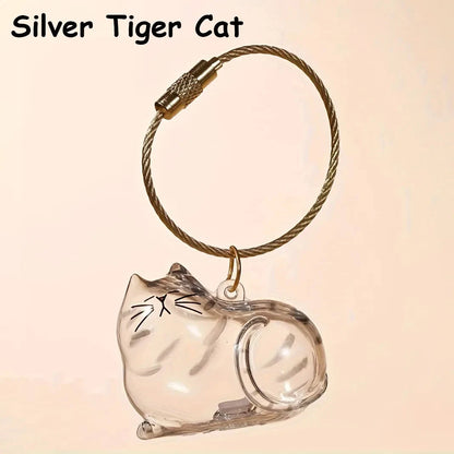 Silver Tabby keepsake keychain displayed on a peach background with its gold-tone loop.
