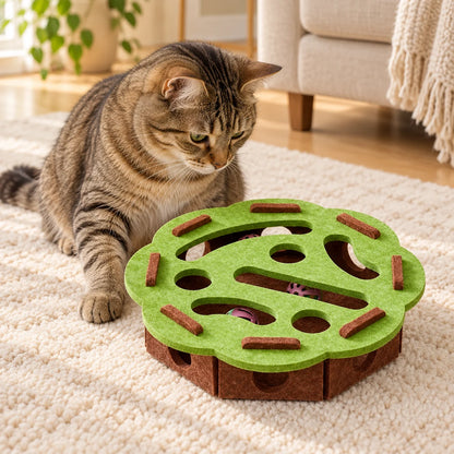 Tabby cat beside a green felt puzzle with brown base and bell balls inside