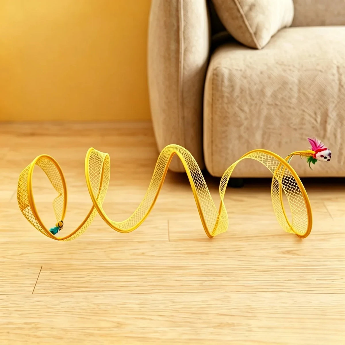 Yellow collapsible spiral cat tunnel on a wood floor beside a sofa.