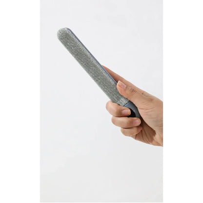 Detached narrow gray cleaning brush held in a hand beside the long-handle pet hair removal tool.