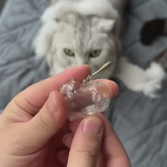 Supplier video showing fur placed in a Silver Tabby cat-shaped keepsake and the loop being attached.